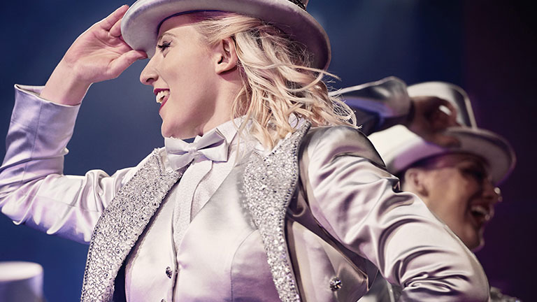 a woman in a silver costume with silver top hat