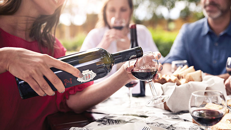 woman pouring a glass of wine