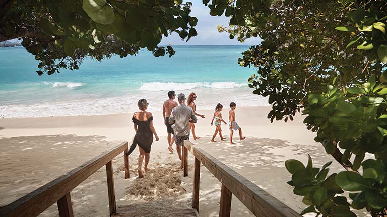 Family walking onto the beach
