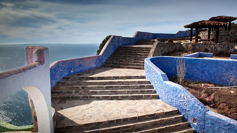 an outdoor stone staircase with an ocean view