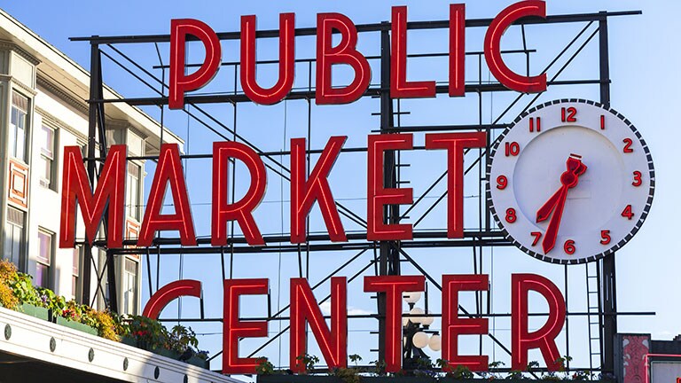 Public Market Center sign with large clock.
