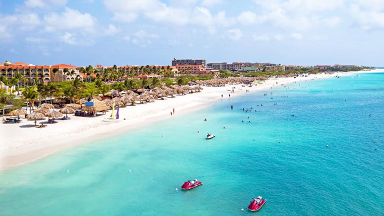 People swimming in the waters of Eagle Beach