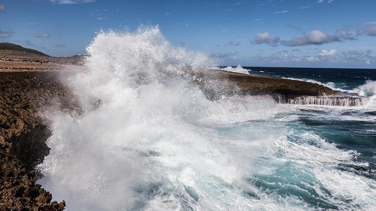waves crashing against seaside bluffs