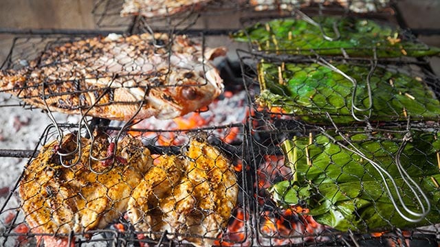 food being prepared on a charcoal grill