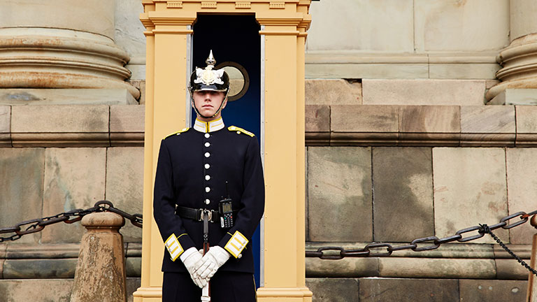 A guard standing in front of a building in Stockholm