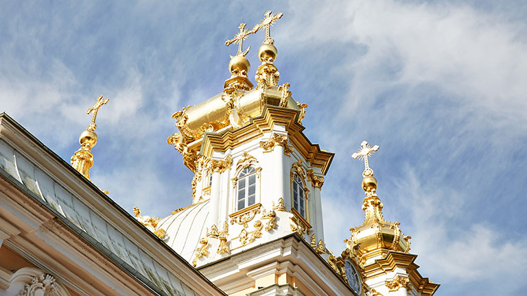 Golden crosses atop a white spire