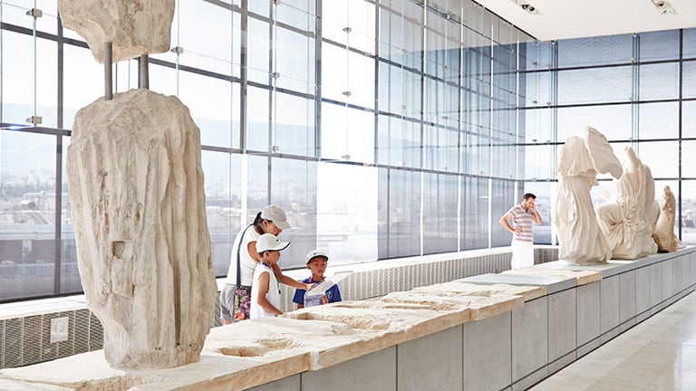 Family seeing sculptures in Athens, Greece