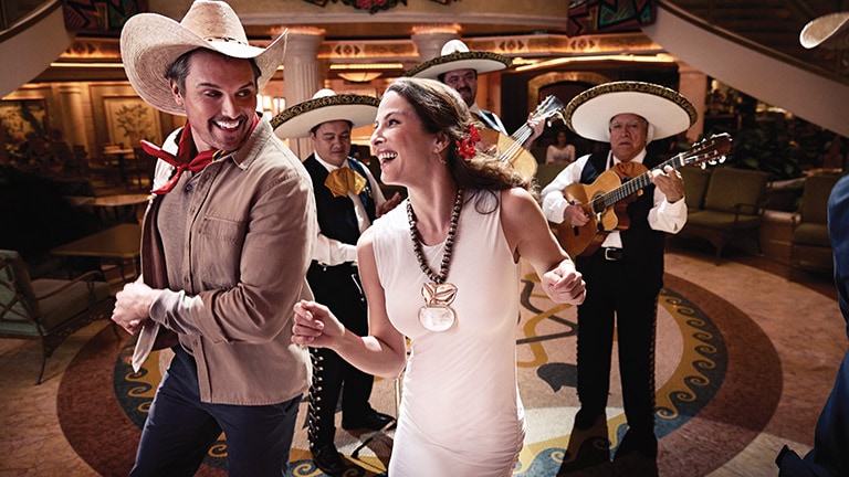 couple dancing to spanish music in a Princess Cruise ship piazza