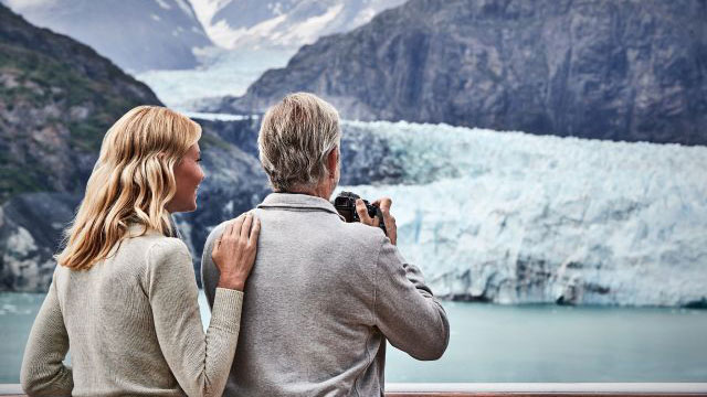 A couple viewing a glacier on an Alaska Cruise.