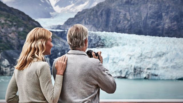 A couple viewing a glacier on an Alaska Cruise.