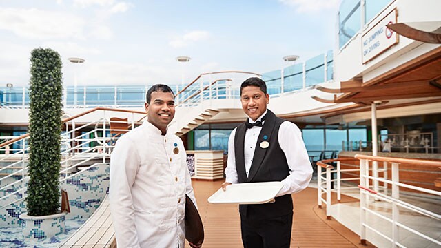two wait staff memebers standing on the top deck
