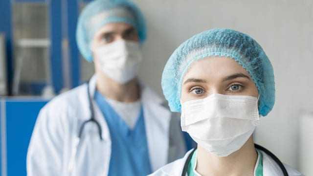 medical staff with masks and hair cover