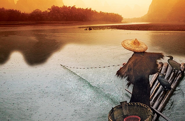 Fisherman fishing in southeast Asia as seen from an Asia cruise